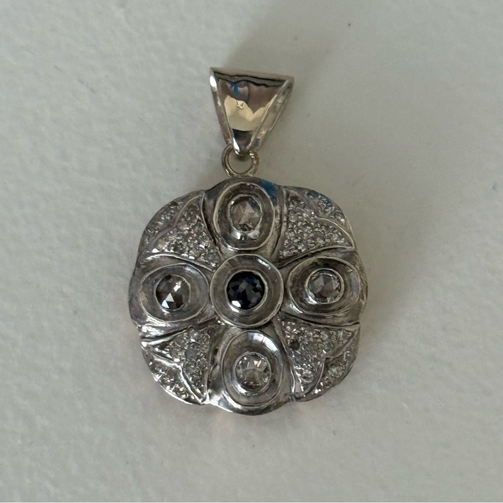 Two tone silver and 14k yellow gold with rose cut white and black diamonds.